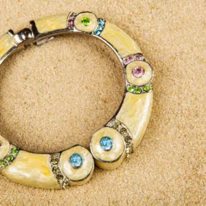 Colorful bracelet on sandy background.